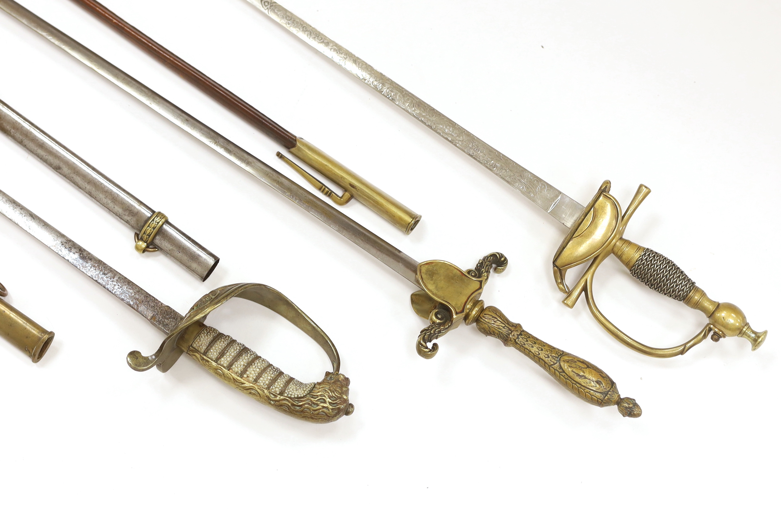 Three 20th century short swords; a court sword in a leather scabbard, a naval style sword, plus another with initials ‘MS’ to guard, blade 76cm